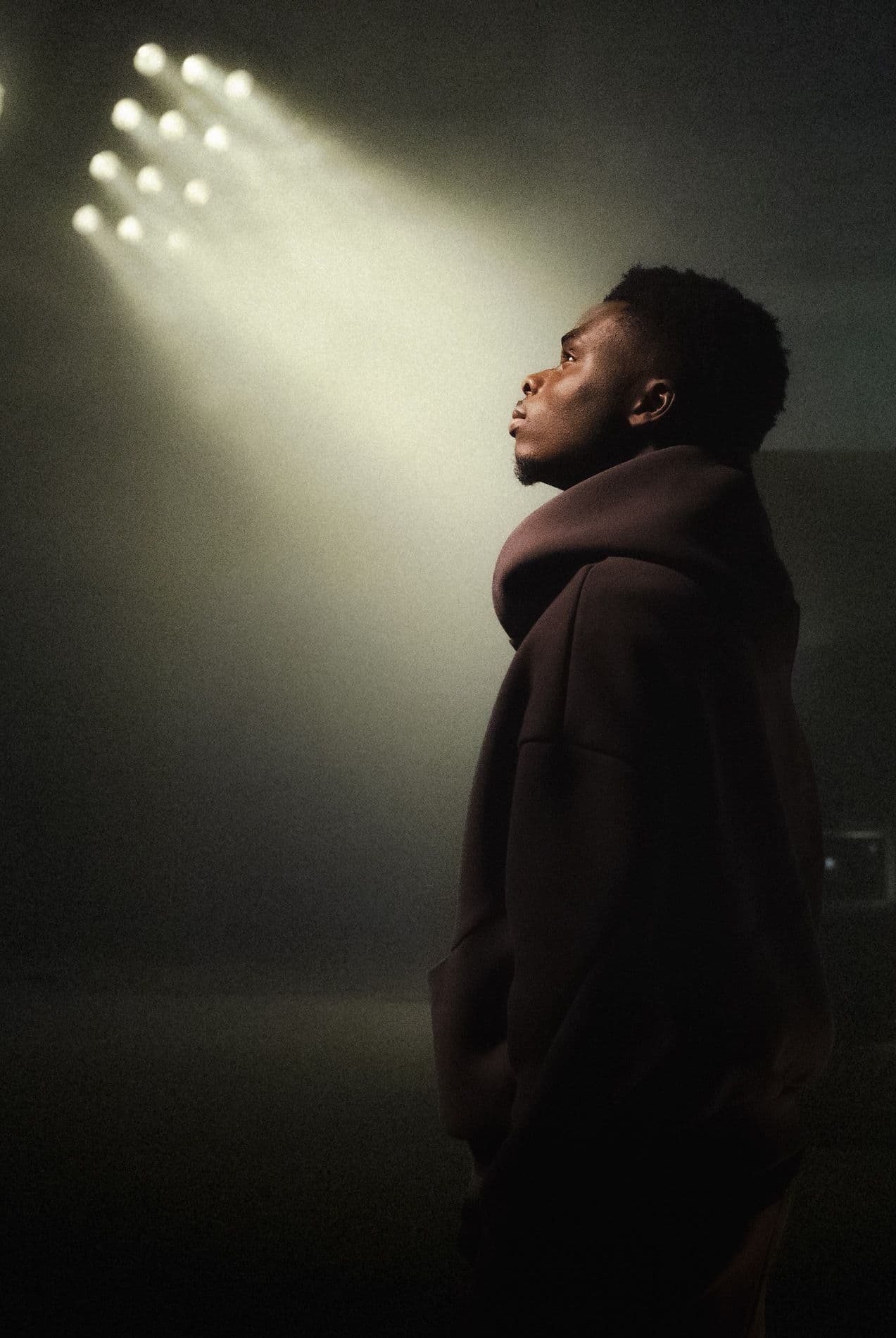 young person looking up at lights